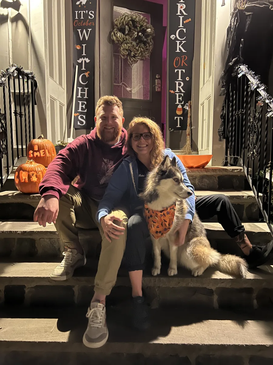 Andrew, Rachel, and Misha the husky on Halloween